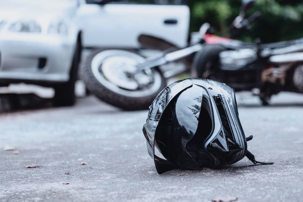 helment-motorcycle-accident photo of helmet on street next to motorcycle after accident