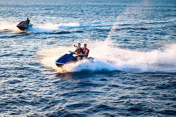 Photo of two waverunners riding along the coast